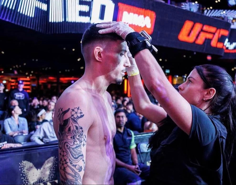 Professional Cutwoman Melissa Karagianis managing athlete trauma and injury in the MMA ring, demonstrating anatomical precision and high-stakes care.